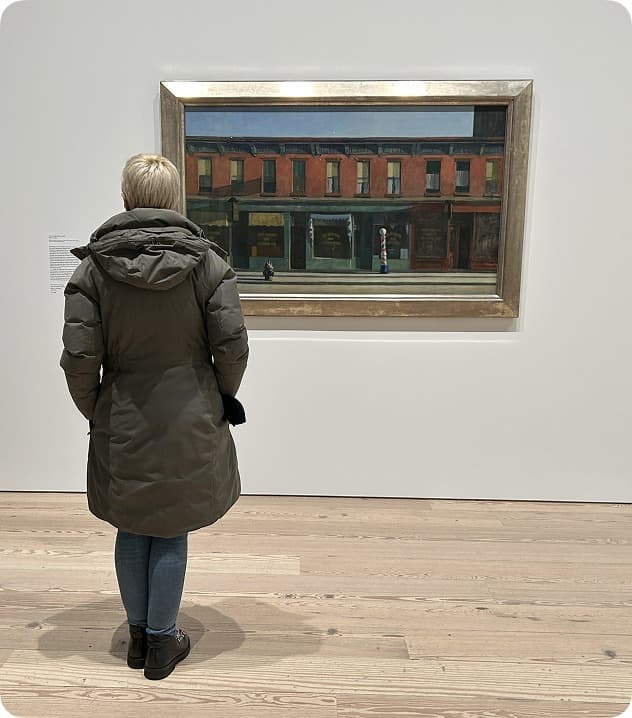 Visitor looking at "Early Sunday Morning" at the Whitney